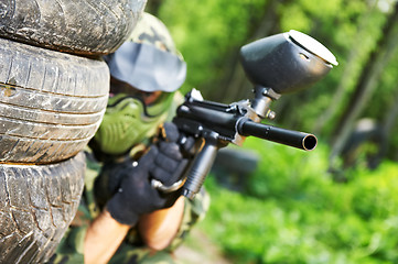 Image showing paintball player under cover