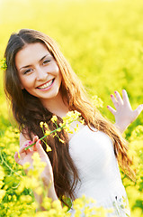 Image showing girl with flowers at summer field