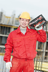 Image showing portrait of construction worker with saw