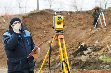 Image showing surveyor works with theodolite tacheometer