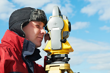 Image showing surveyor works with theodolite tacheometer