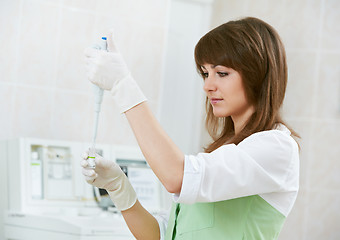 Image showing female doctor with dropper