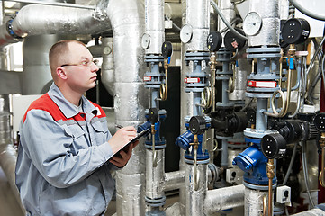 Image showing heating engineer in boiler room