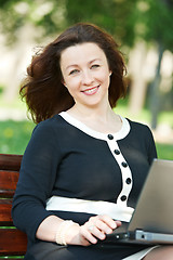 Image showing female boss with computer outdoors