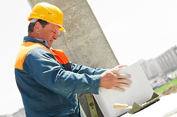 Image showing bricklayer at construction masonry works