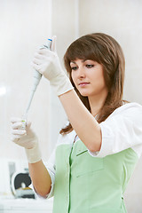 Image showing female doctor with dropper