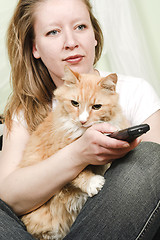 Image showing girl watching tv with cat