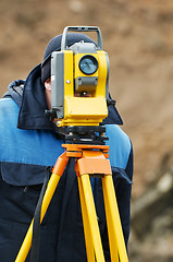 Image showing surveyor works with theodolite tacheometer