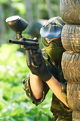 Image showing paintball player under cover