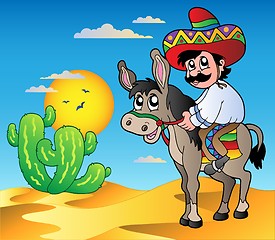 Image showing Mexican riding donkey in desert