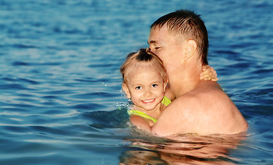 Image showing Dad and daughter swimming in the sea