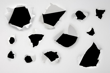 Image showing Closeup of a dark holes on white paper set