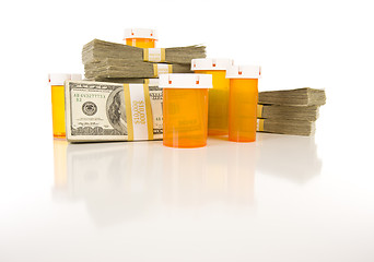 Image showing Medicine Bottles and Stacks of Hundreds of Dollars