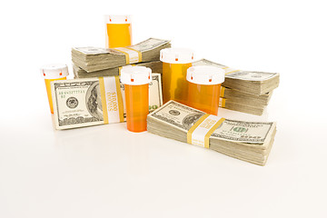 Image showing Medicine Bottles and Stacks of Hundreds of Dollars