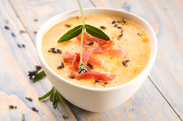 Image showing fresh melon soup with parma ham and lavender flower