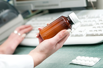 Image showing closeup hand of chemist with drug