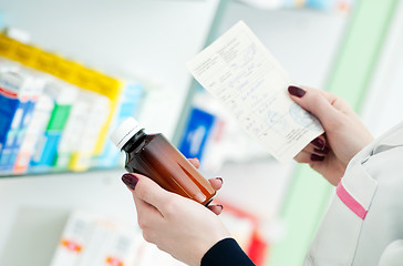 Image showing closeup hand of chemist with drug