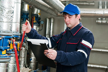 Image showing heating engineer in boiler room