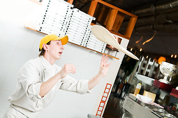 Image showing Pizza baker juggling with dough