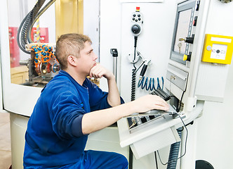 Image showing worker operating CNC machine center