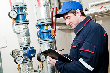 Image showing heating engineer in boiler room