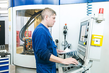 Image showing worker operating CNC machine center