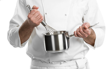 Image showing chef hands with whisk and pan isolated