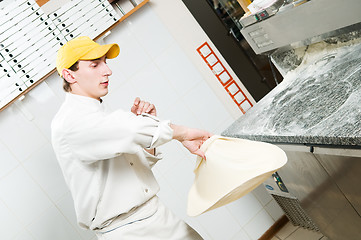 Image showing Pizza baker juggling with dough