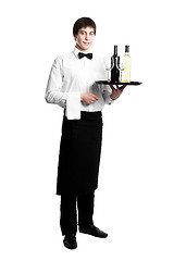 Image showing Waiter sommelier with bottles of wine and stemware on tray