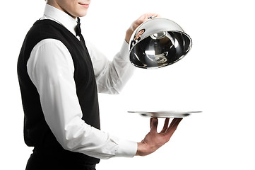 Image showing hands of waiter with cloche lid cover