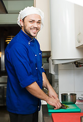 Image showing chef cutting greens