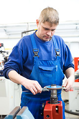 Image showing worker checking cutting tool