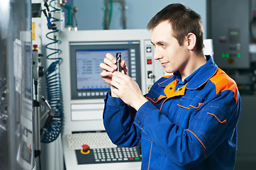 Image showing worker examining detail