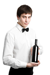 Image showing Waiter sommelier with wine bottle and stemware