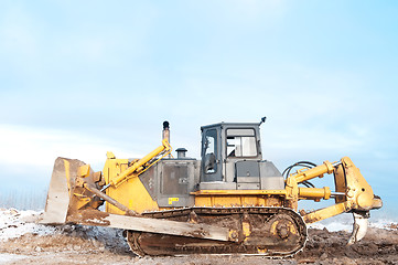 Image showing bulldozer loader at winter frozen soil works