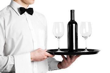 Image showing Waiter hands with wine bottle and stemware on tray