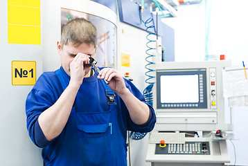 Image showing worker measuring detail