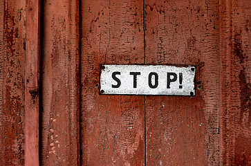 Image showing a sign saying ''stop''on the grunge wooden background 