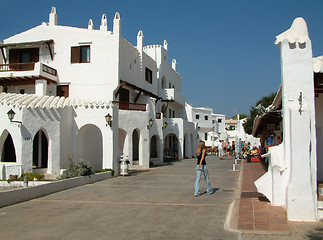 Image showing girl walking along a village road