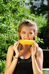 Image showing woman eating corn-cob