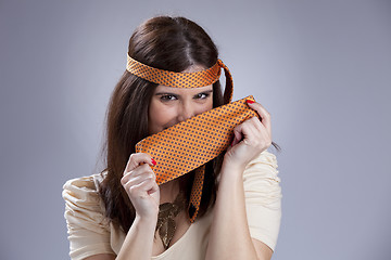 Image showing Woman hidding behind a necktie