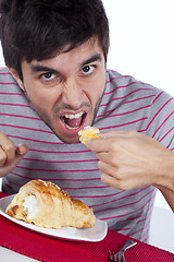 Image showing Man eating a cake