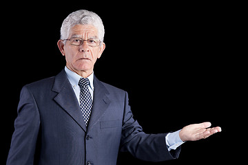 Image showing Senior businessman showing something