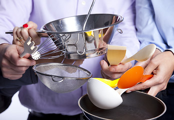 Image showing Hands holding kitchenware tools