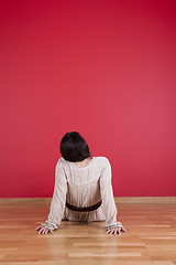 Image showing Woman looking to a red wall