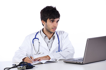 Image showing frendly young doctor working with his laptop