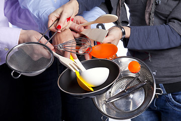 Image showing Hands holding kitchenware tools