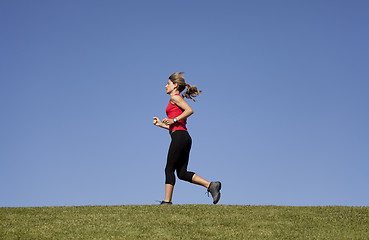 Image showing Running at the top of the hill