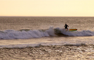 Image showing Surfing on a sun down