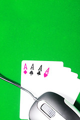 Image showing An online gaming concept with computer mouse, four aces and green felt